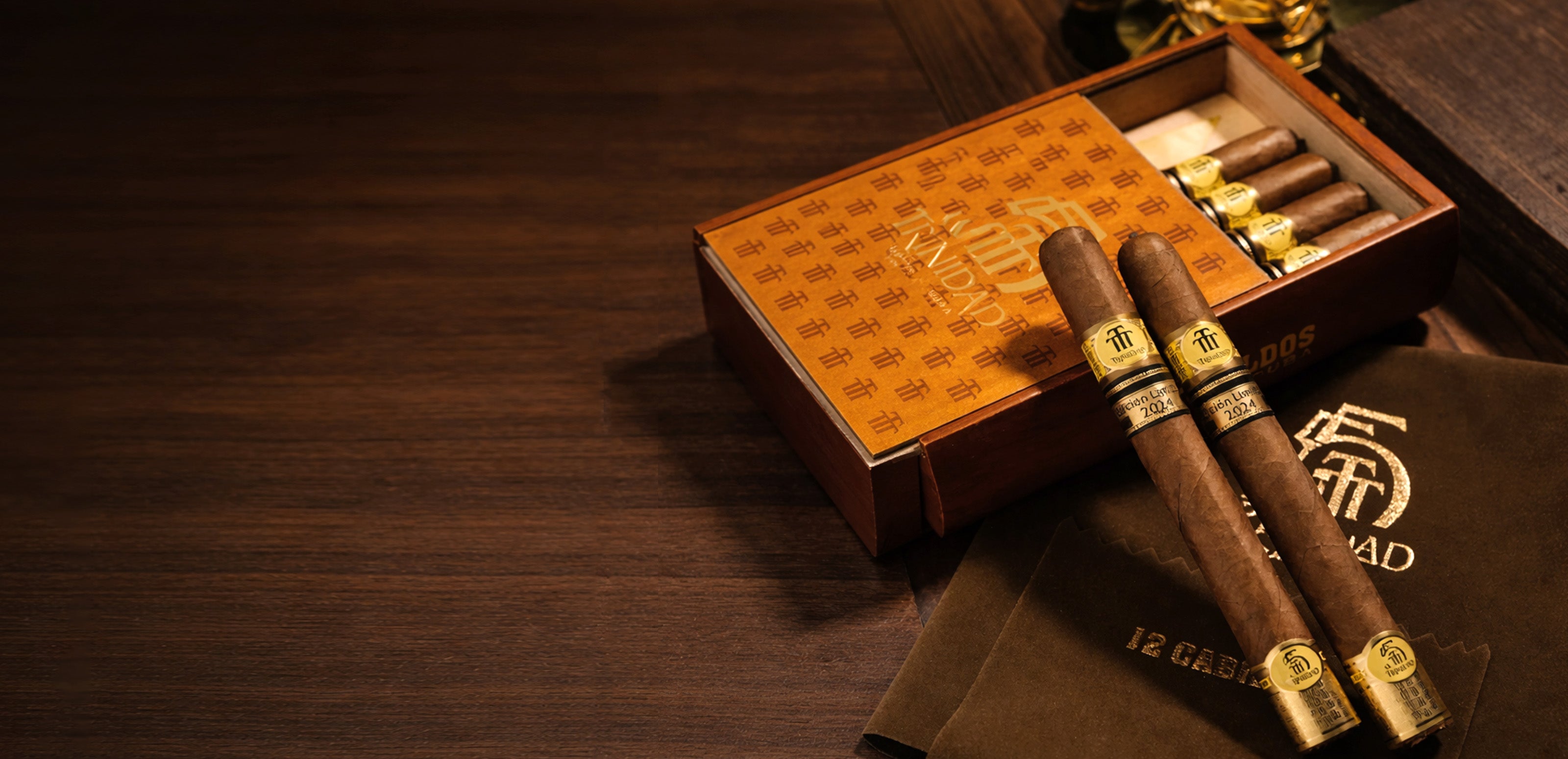 Cigars with a humidor and branded box on a wooden surface